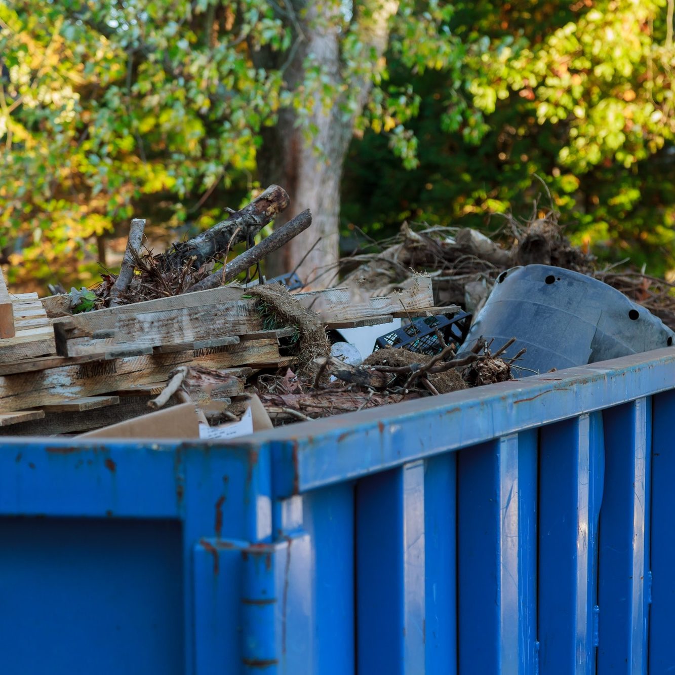 Industrial dumpster filled Loaded dumpster near a construction site, home renovation Industrial dumpster filled Loaded dumpster near a construction site, home renovation